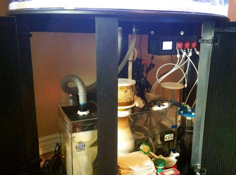 Aquarium filtration system setup under tank.